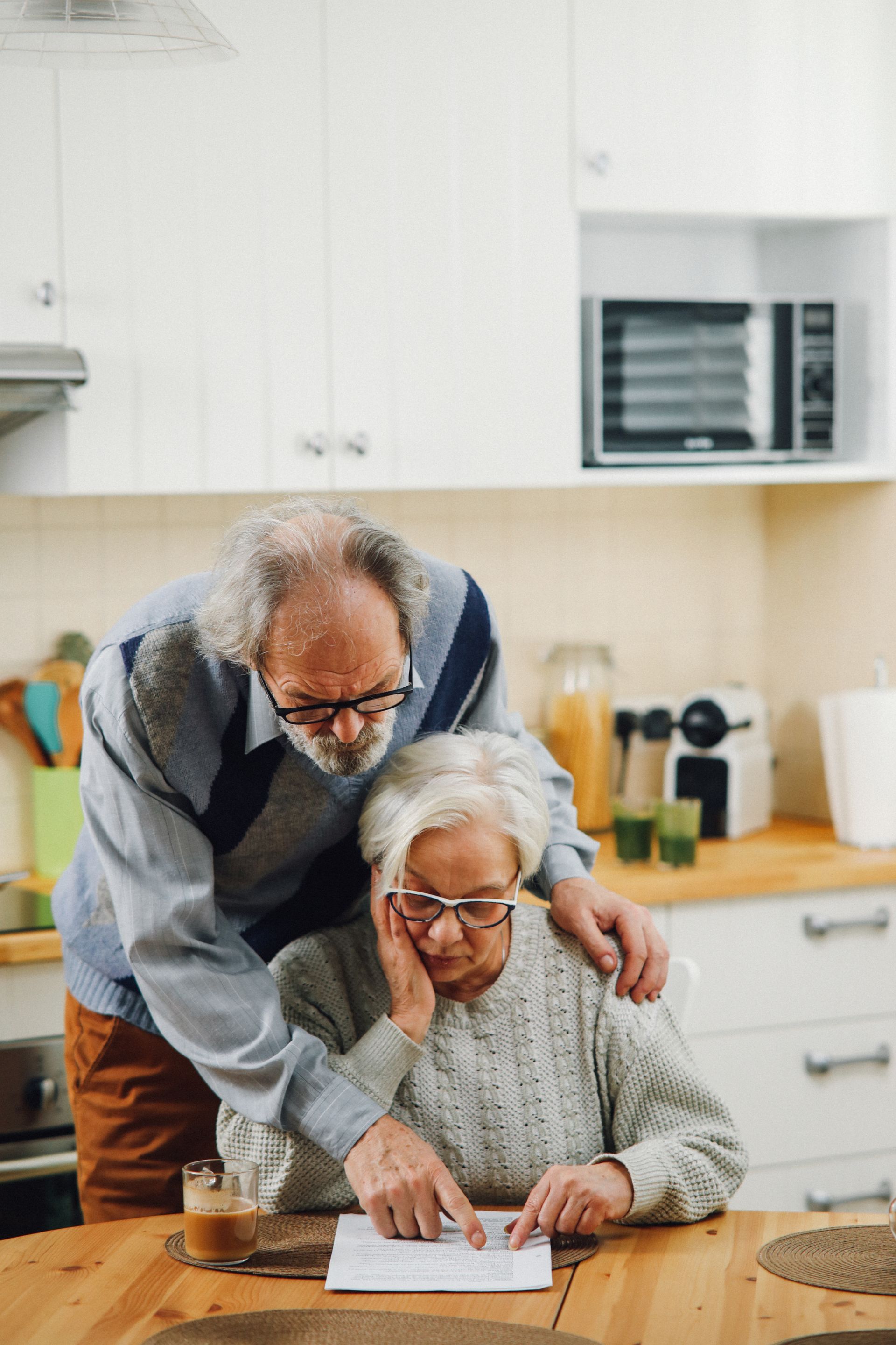 Older couple reviewing their succession plan together at the kitchen table