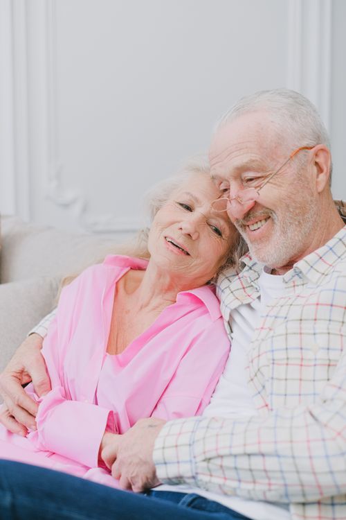 Older couple smiling warmly, feeling confident about their plan